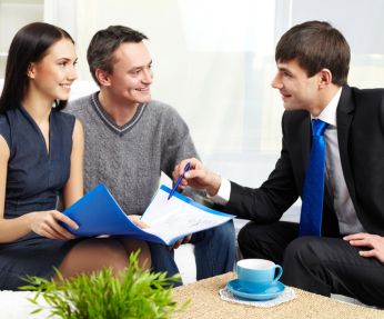couple sitting with Realtor Attorney in Queens, NY