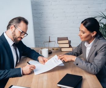 woman pointing to paper with Attorney For Buying A Home in Queens, NY