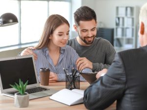 Couple meeting with notary public in an Nassau County office