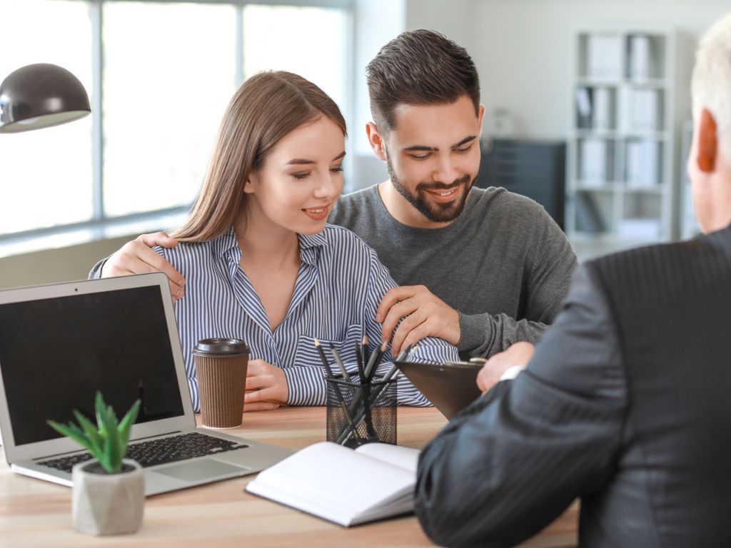 Couple meeting with notary public in an Nassau County office