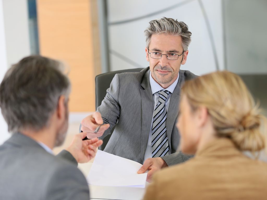 Real Estate Attorney Reviewing a Contract with a Married Couple in Oceanside, NY