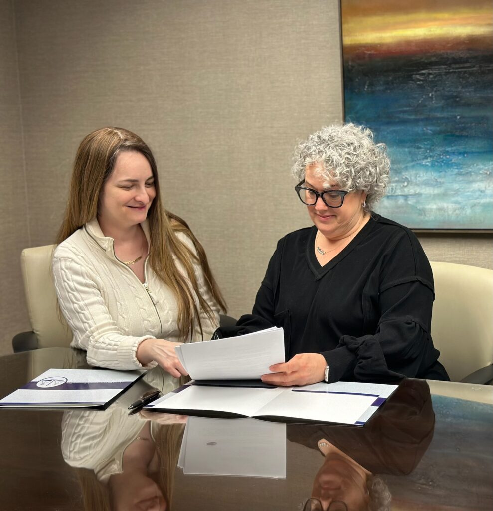 The Law Offices of Aaron I. Katsman (Katzman) team reviewing documents with a client at our office in Long Island, NY