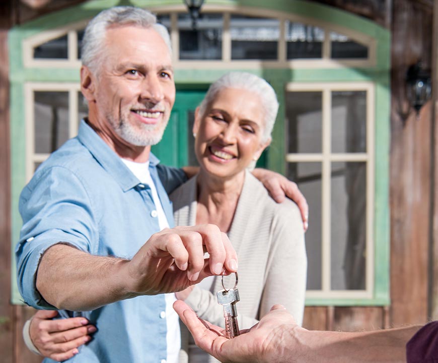 Senior couple selling their home and giving keys to their real estate attorney in Hempstead, NY