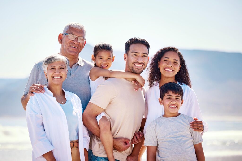 Family Smiling on Beach After Estate Planning in Hempstead, NY